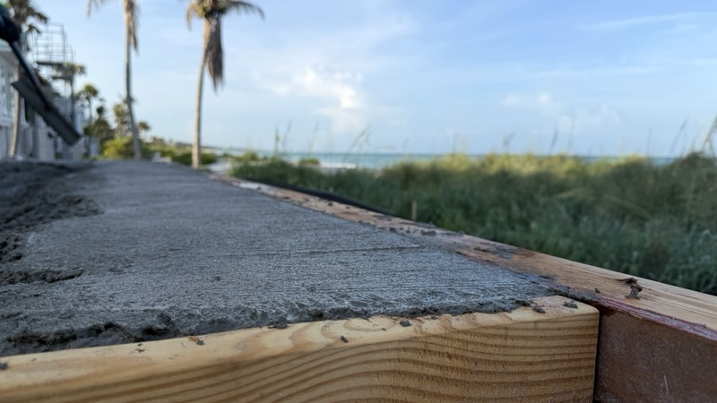 Fresh slab edge above the dunes, with the Gulf beyond