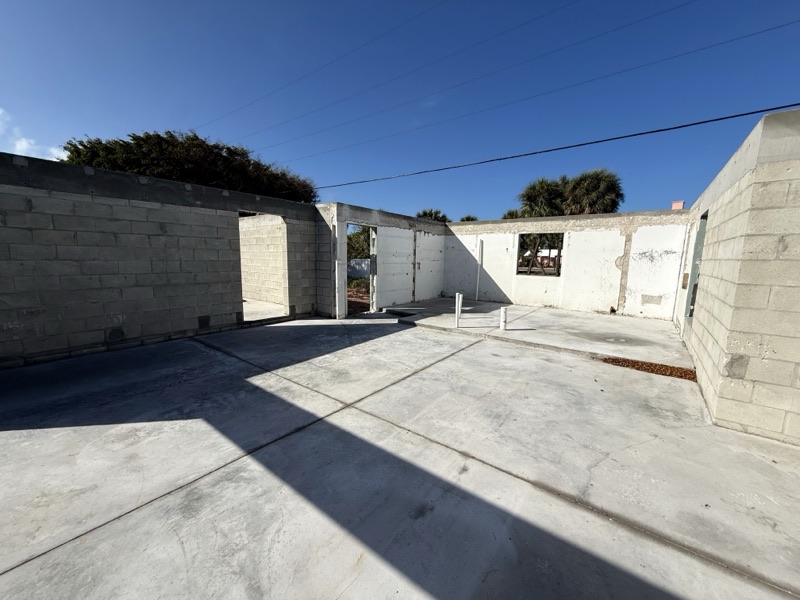 Concrete block walls going up on a fresh slab at a custom home