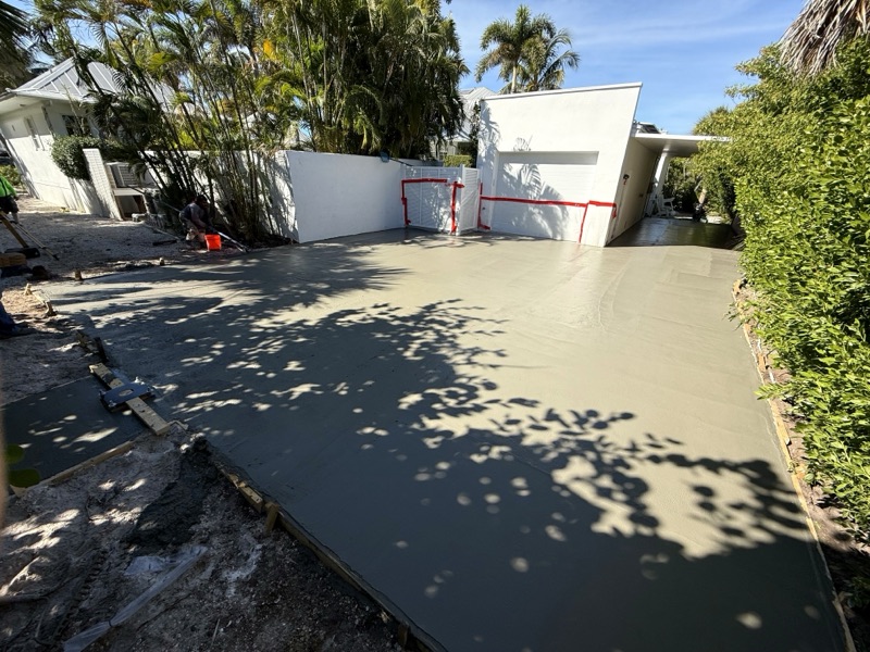 Freshly troweled slab curing in the shade of the palms